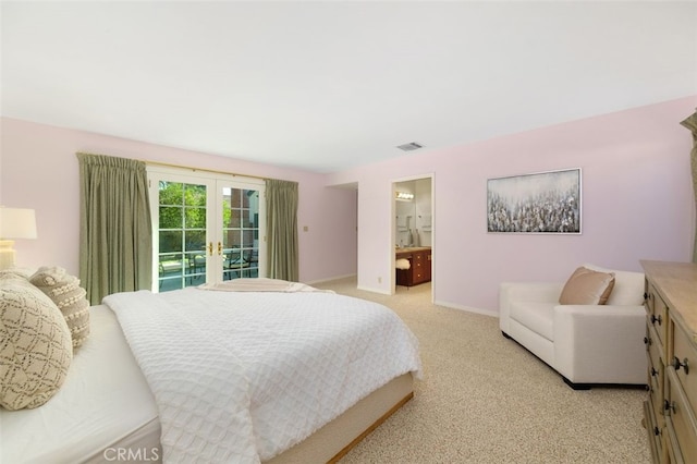 carpeted bedroom with access to outside, french doors, and ensuite bathroom