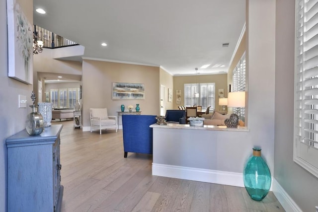 interior space featuring light hardwood / wood-style floors and ornamental molding