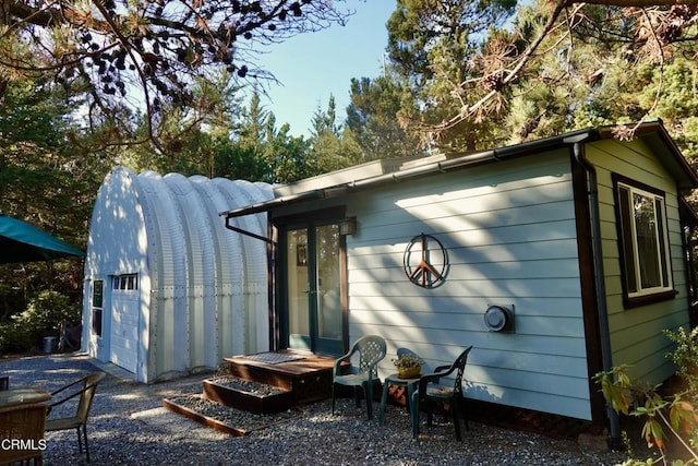 rear view of house with an outbuilding and a garage