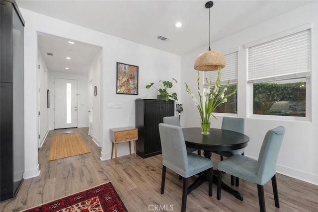 dining space with light hardwood / wood-style floors