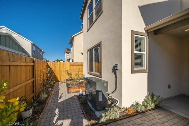 view of property exterior featuring ac unit and a patio