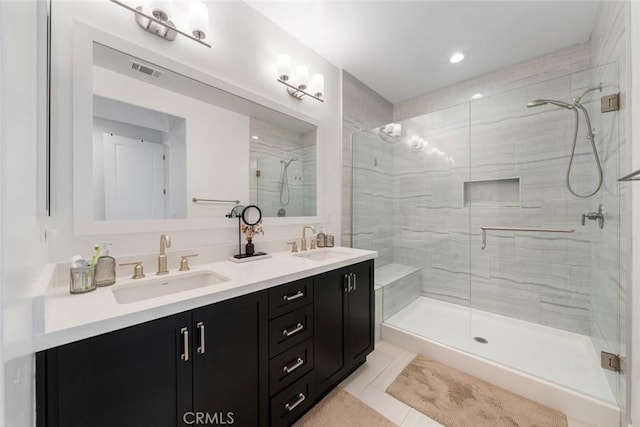 bathroom featuring an enclosed shower, vanity, and tile patterned flooring