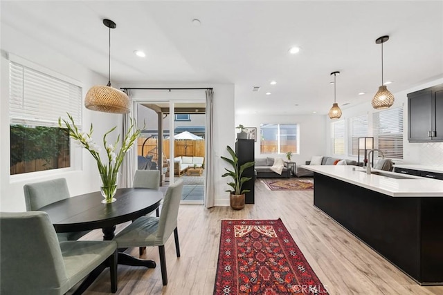 dining room featuring sink and light hardwood / wood-style flooring