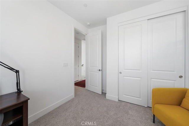 sitting room featuring light carpet