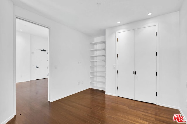 unfurnished bedroom featuring dark hardwood / wood-style flooring