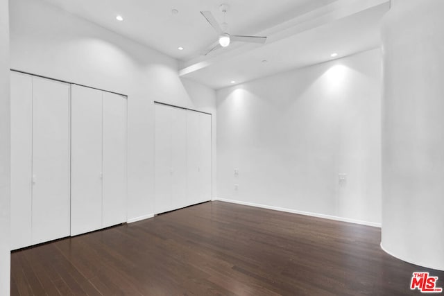 empty room with ceiling fan and dark hardwood / wood-style floors