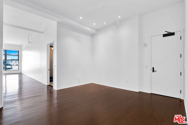 empty room with dark hardwood / wood-style floors