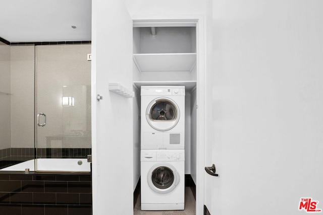 washroom with stacked washing maching and dryer