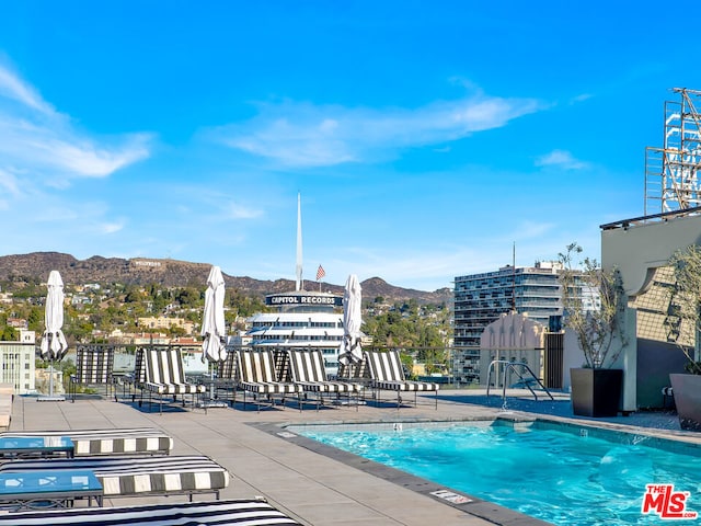 view of pool featuring a mountain view and a patio