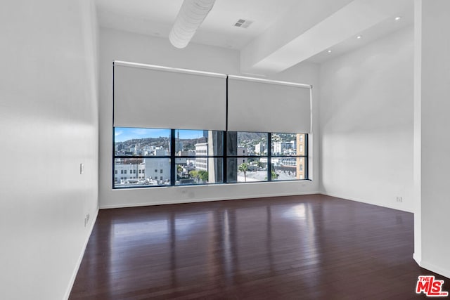 empty room with dark wood-type flooring