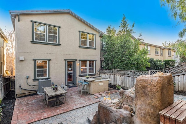 back of property featuring central AC unit and a patio area