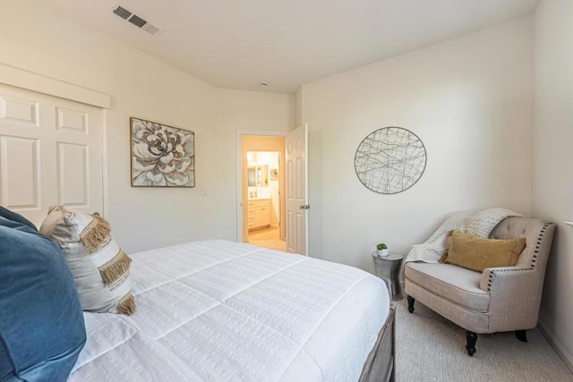 carpeted bedroom with ensuite bathroom