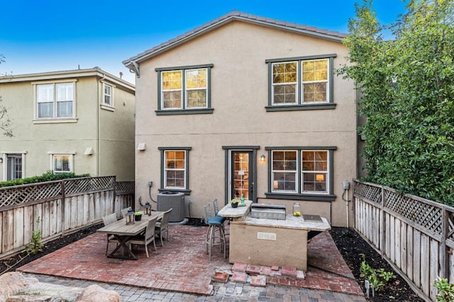 rear view of property featuring central AC and a patio area