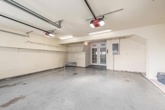 garage featuring a garage door opener, electric panel, and french doors