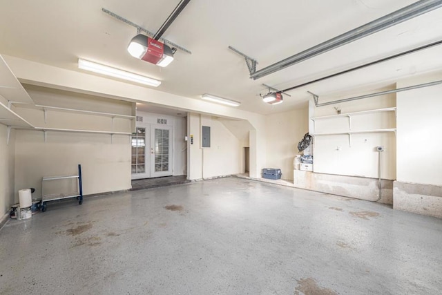 garage with a garage door opener, electric panel, and french doors