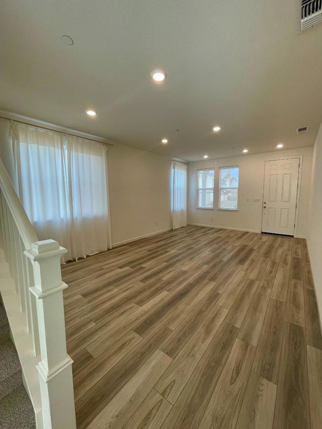 unfurnished living room with hardwood / wood-style floors