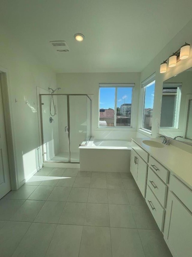 bathroom with tile patterned flooring, shower with separate bathtub, and vanity