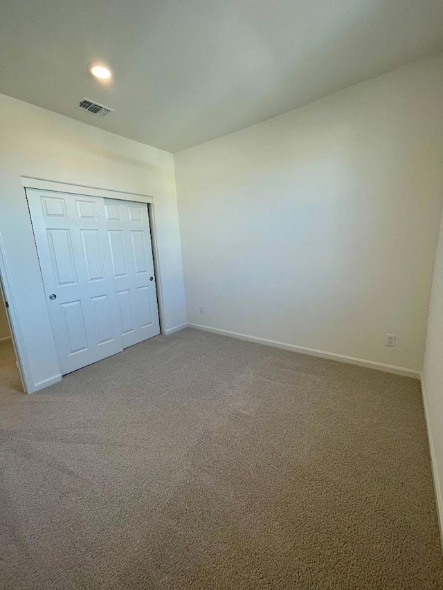 unfurnished bedroom with carpet and a closet