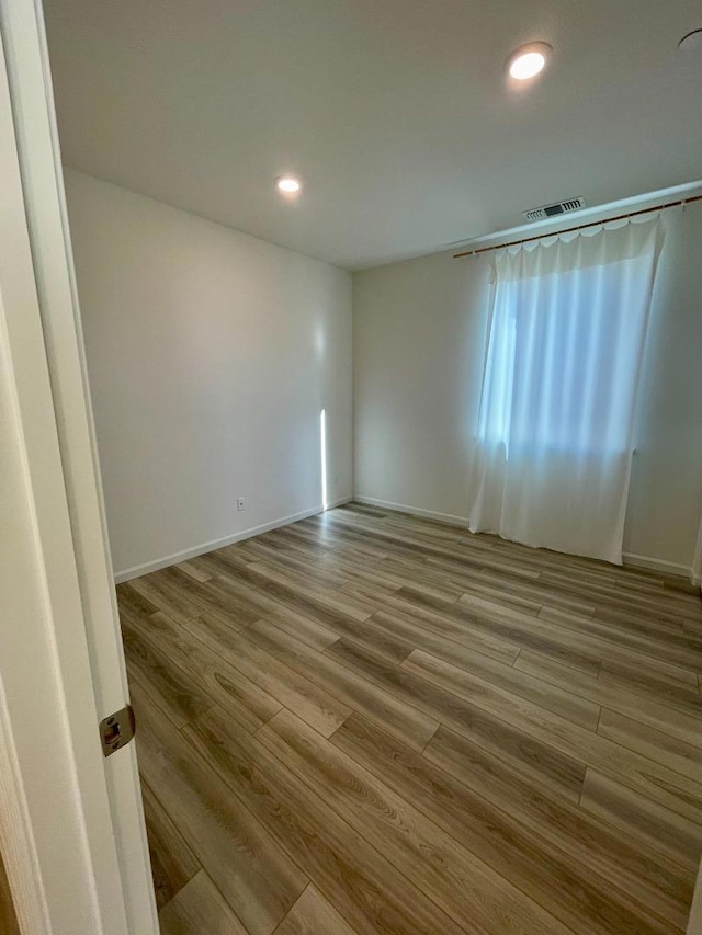 unfurnished room featuring wood-type flooring