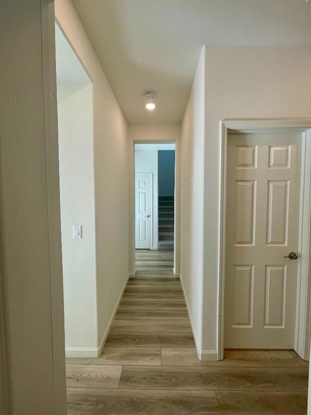 hallway with light wood-type flooring