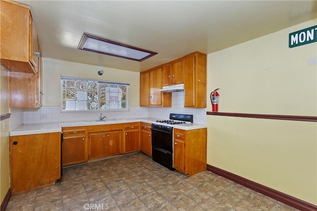 kitchen featuring sink, backsplash, and range with gas stovetop