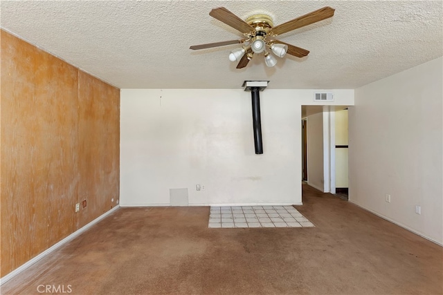 carpeted empty room featuring a textured ceiling and ceiling fan