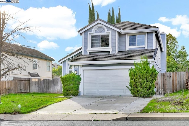 view of front of property featuring a front yard and a garage