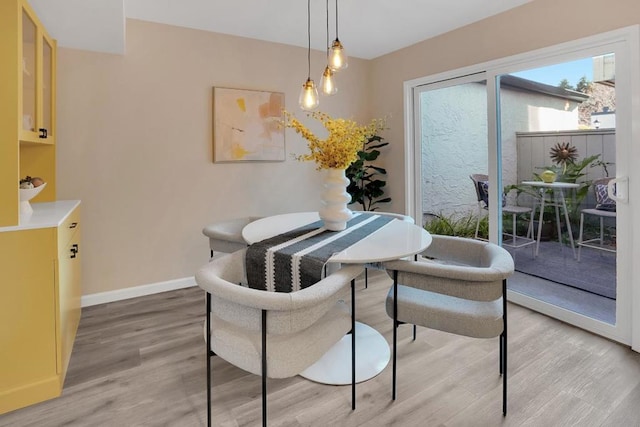 dining space with hardwood / wood-style floors