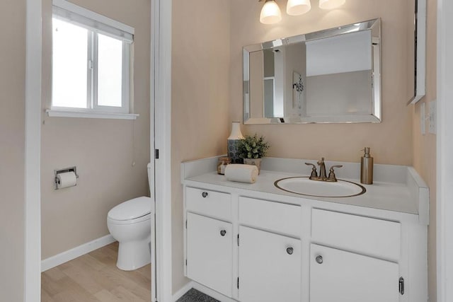 bathroom featuring hardwood / wood-style floors, toilet, and vanity