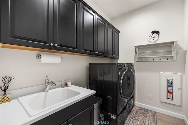 laundry room with cabinets, sink, and washing machine and dryer