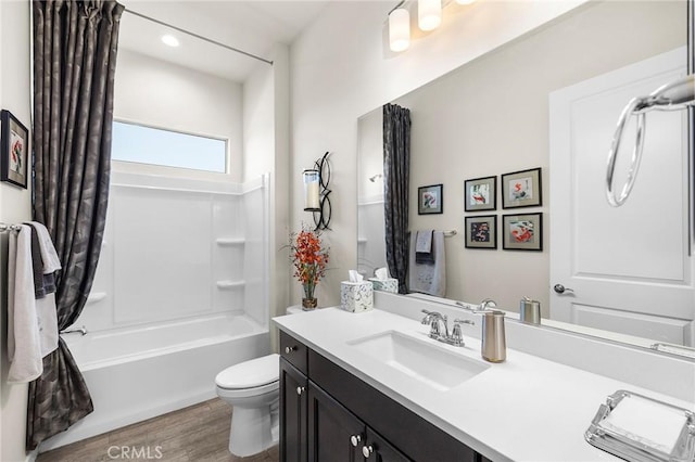 full bathroom featuring toilet, bathtub / shower combination, vanity, and hardwood / wood-style floors