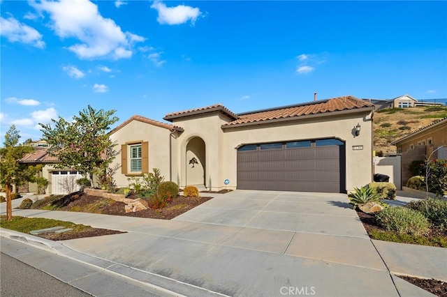 mediterranean / spanish-style house featuring a garage