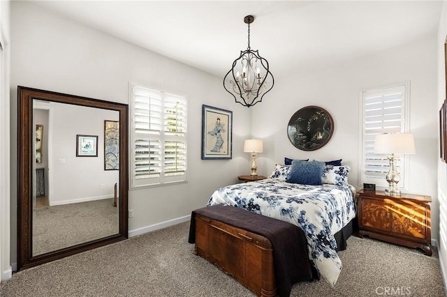 carpeted bedroom featuring a chandelier