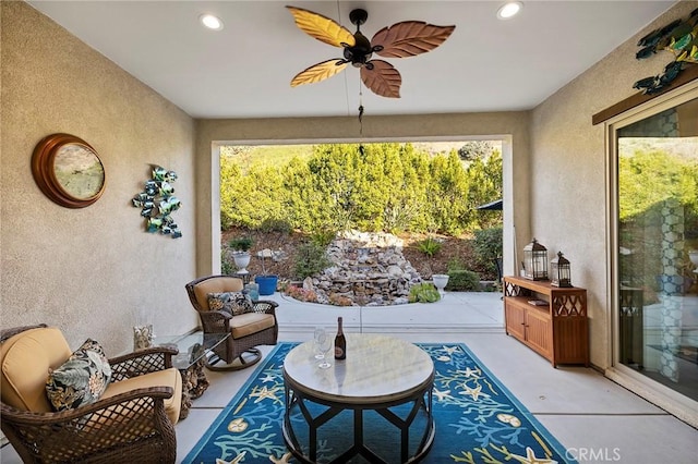 sunroom featuring ceiling fan