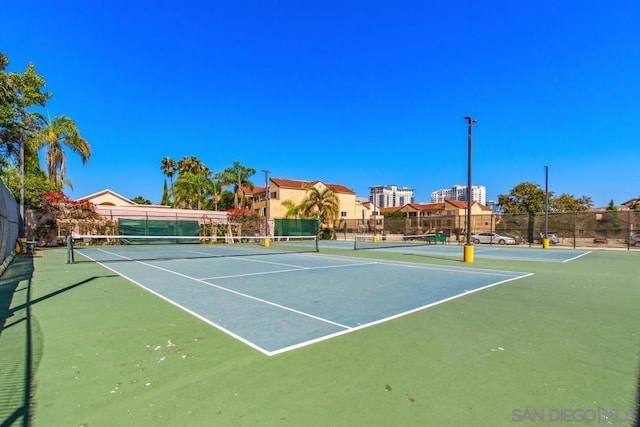 view of tennis court featuring basketball court