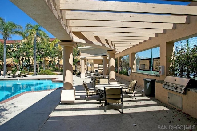 view of pool with a pergola, a patio, and area for grilling