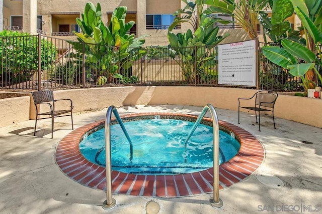 view of swimming pool featuring a patio area and a community hot tub