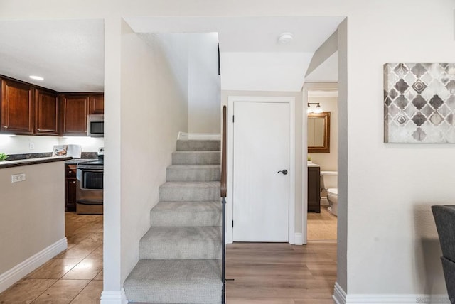 staircase with hardwood / wood-style floors