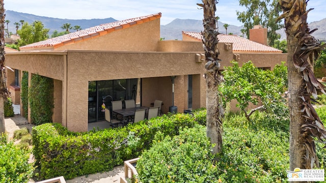 rear view of house featuring a mountain view