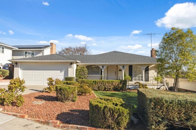 ranch-style home featuring a garage, a porch, and a front lawn