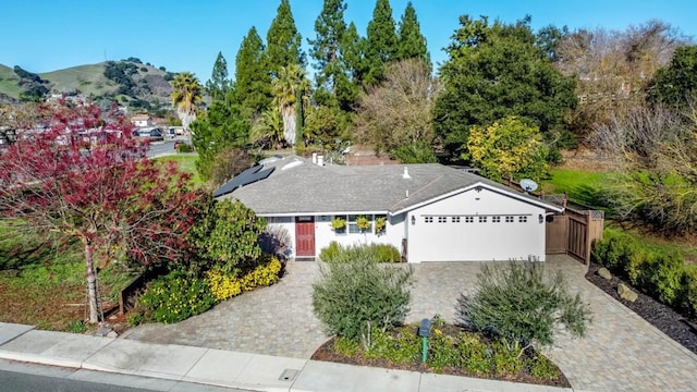 view of front of property featuring a garage and a mountain view