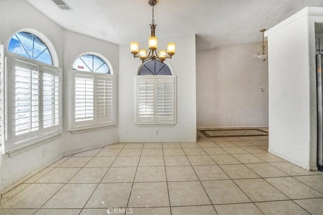 unfurnished dining area with light tile patterned floors and a chandelier