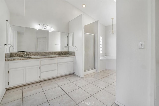 bathroom featuring independent shower and bath, tile patterned floors, and vanity