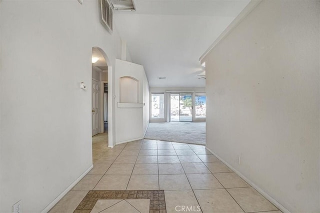 hall with light tile patterned floors