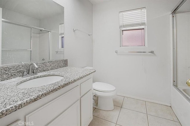 full bathroom featuring toilet, vanity, tile patterned flooring, and combined bath / shower with glass door