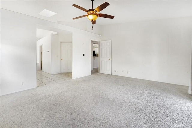 carpeted spare room featuring ceiling fan and lofted ceiling