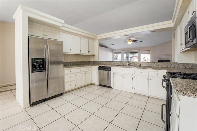 kitchen with white cabinets, appliances with stainless steel finishes, sink, ceiling fan, and light tile patterned floors