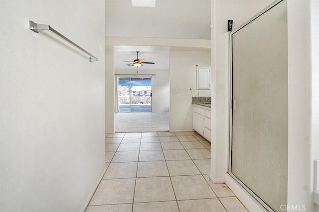 corridor featuring light tile patterned floors