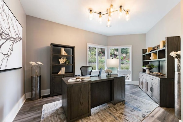 office with hardwood / wood-style flooring and a chandelier