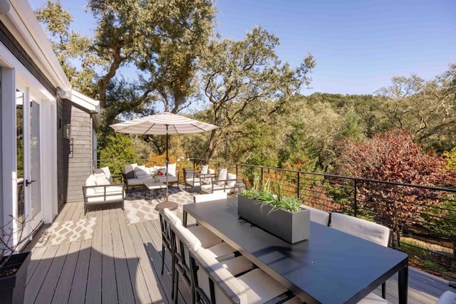 wooden terrace with an outdoor living space